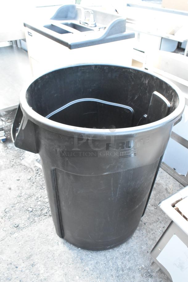 BRAND NEW Rubbermaid BRUTE 55-gallon black trash can; minor scratches, durable plastic, executive style branding visible.