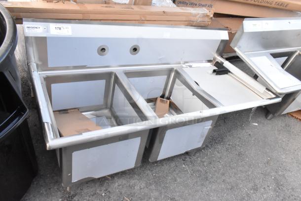 Regency 600S2162018R stainless steel 2-bay sink, right side drain board, new scratch and dent condition, visible label.