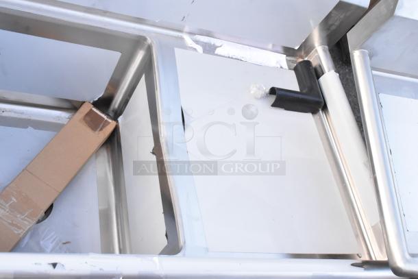 Regency 600S2162018R stainless steel 2-bay sink with right-side drain board, brand new with visible scratches and dents.