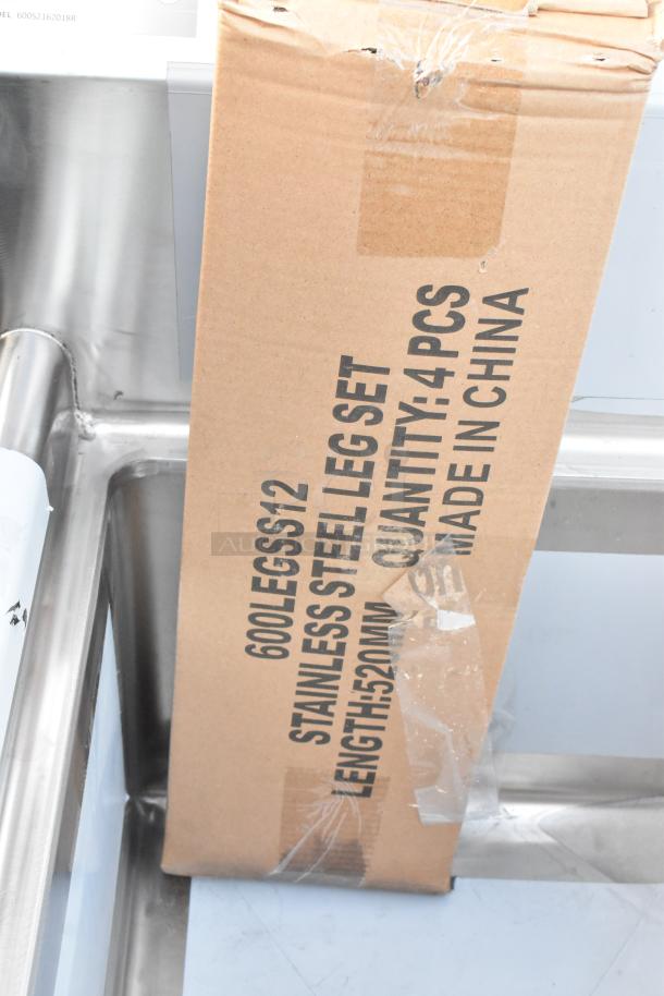 BRAND NEW Regency 600S2162018R stainless steel 2 bay sink with right side drain board. Scratch and dent condition. Box labeled "Stainless Steel Leg Set."
