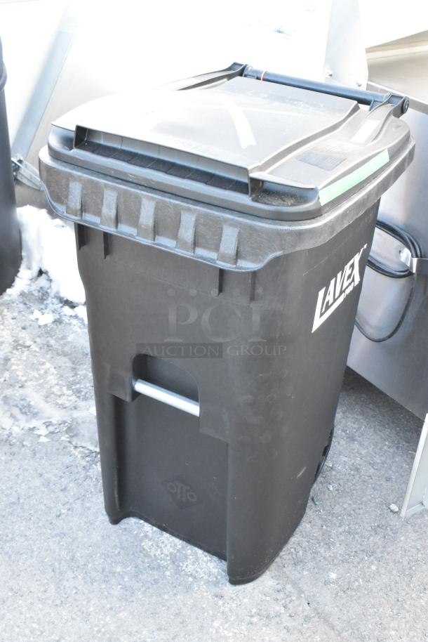 Brand new Lavex black poly trash can with minor scratches and dents, features sturdy wheels and a hinged lid.