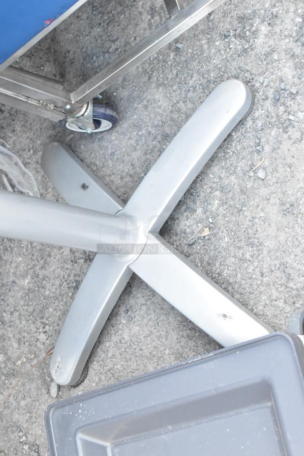 Dish caddy dolly with wheels and a silver metal table base on a concrete surface; moderate wear.
