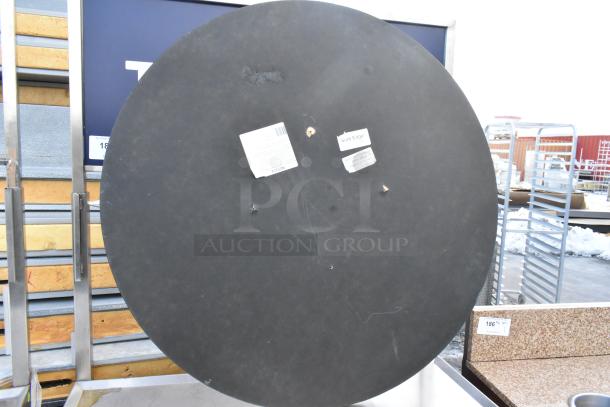 Round tabletop with visible wear, having two labels marked "Sure Edge". Ideal for furniture replacement or DIY projects.