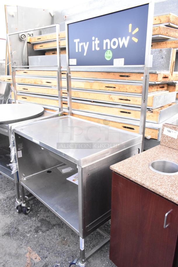 National Cart Co stainless steel table with under shelf, drawer, and commercial casters. Excellent condition.