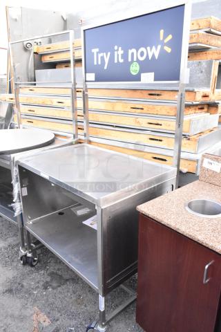 National Cart Co stainless steel table with under shelf, drawer, and commercial casters. Excellent condition.