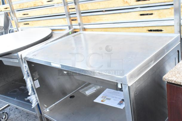 National Cart Co stainless steel table with under shelf, drawer, and commercial casters; used condition.
