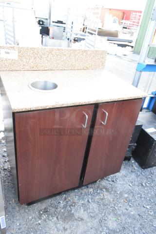 Wood pattern 2-door trash can shell with countertop, trash deposit hole; granite-like surface, metal handles, good condition.