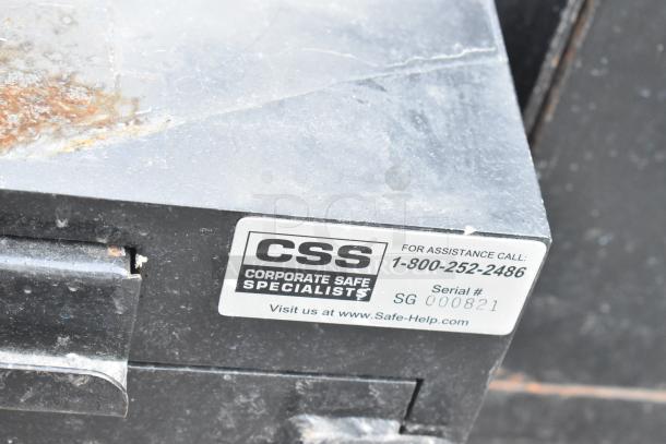 Corporate Safe Specialists black metal safe, single compartment, no combination. Visible label with contact info, serial #SG 000821.