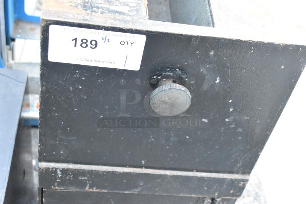 Black metal single compartment safe, no combination, visible wear, auction label "189" attached.