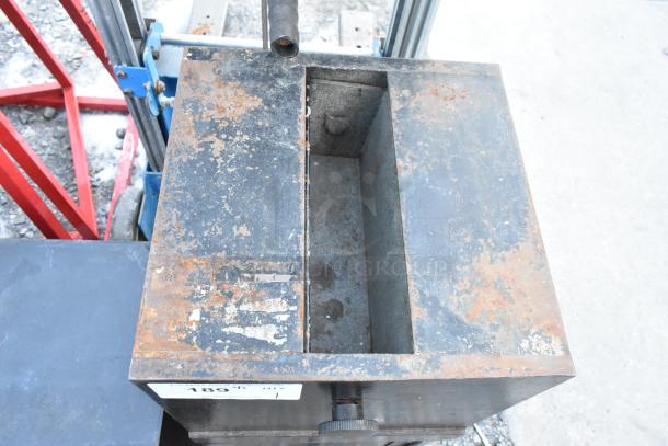 Black metal safe with a single compartment showing rust and wear. No combination provided. Markings include "189" label.