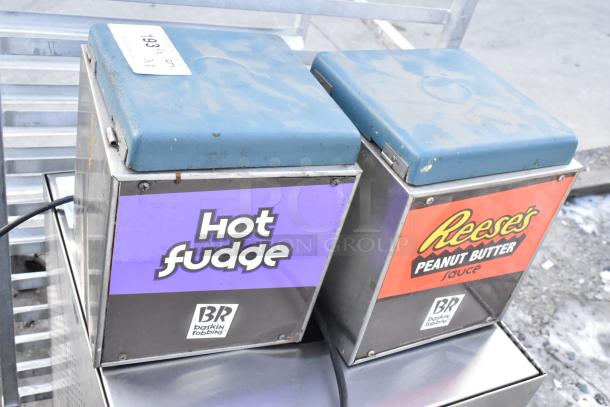 Karma 104 countertop chocolate warmer, 120 volts, dual units, labeled "Hot Fudge" and "Reese's," signs of wear.