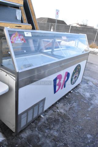 Commercial floor-style ice cream dipping cabinet; 208/250 volts, 1 phase, features glass display, branded graphics on side.