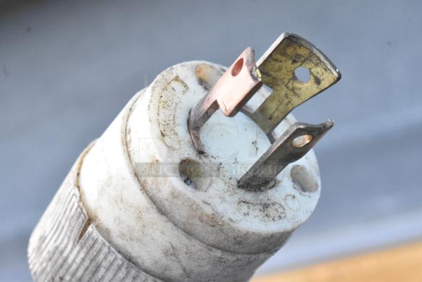 Close-up of a worn electrical plug for a Commercial Floor Style Ice Cream Dipping Cabinet, showing signs of use.