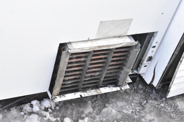 Commercial ice cream dipping cabinet vent, shows moderate wear, 115 Volts, 1 Phase. Visible grate and label on surface.