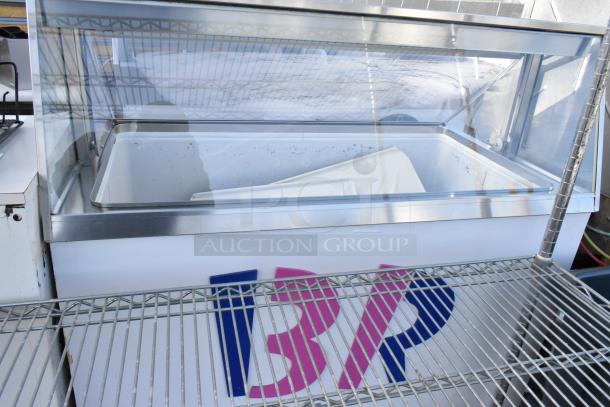 Commercial floor-style ice cream dipping cabinet, clear glass top, visible brand logo, 115 volts, 1 phase, clean condition.