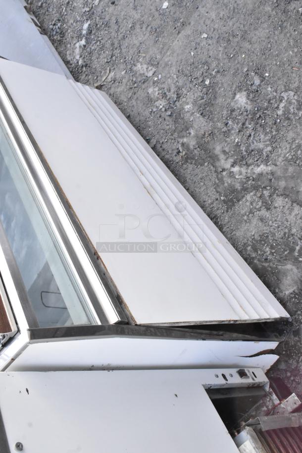 Commercial Novelty Ice Cream Freezer Merchandiser, 115 volts, 1 phase, glass top, white exterior, good condition.