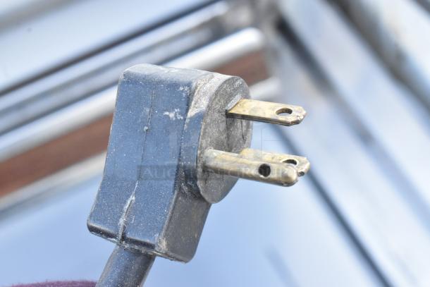 Close-up of a power plug for a commercial novelty ice cream freezer merchandiser. 115 volts, 1-phase connection.