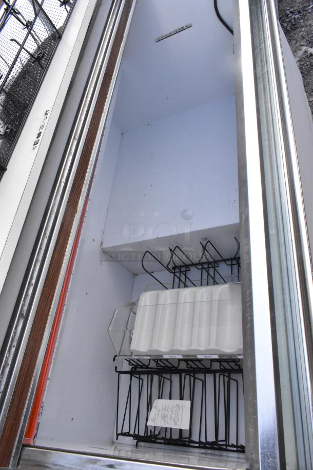 Commercial novelty ice cream freezer merchandiser, 115V, 1 phase, visible wire racks, interior view, good condition.