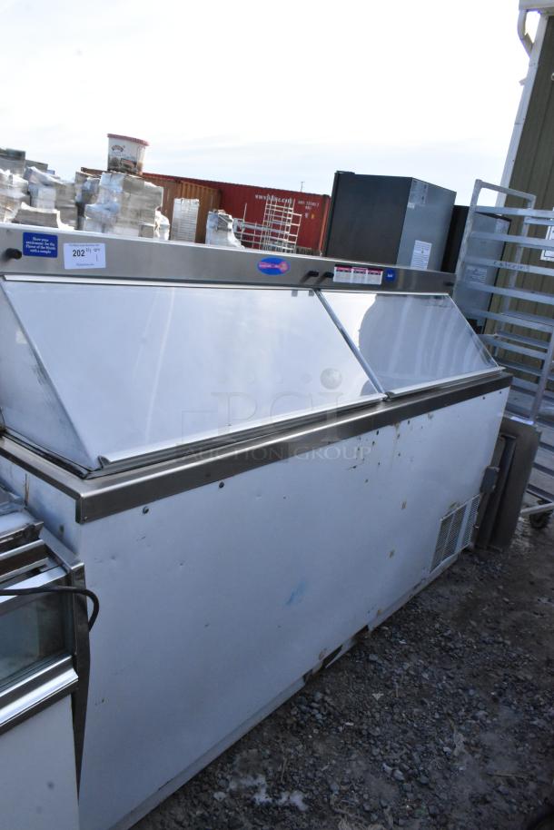 Commercial floor-style ice cream dipping cabinet with metallic finish. Visible signs of wear. Tags indicate item and quantity.
