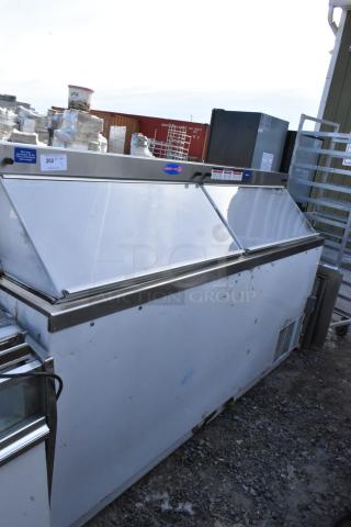Commercial floor-style ice cream dipping cabinet with metallic finish. Visible signs of wear. Tags indicate item and quantity.