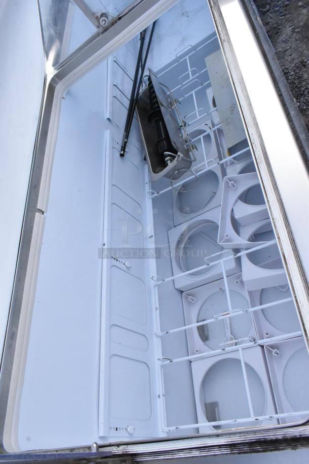 Commercial floor-style ice cream dipping cabinet, spacious interior with multiple compartments, stainless steel finish, excellent condition.