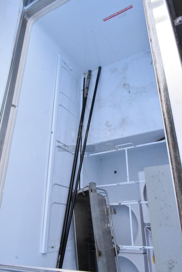 Commercial floor-style ice cream dipping cabinet interior, showcasing storage compartments and a "Keep Product Below Red Line" label.