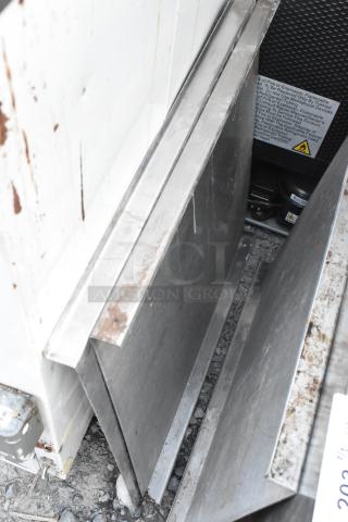 Four metal panels with visible wear and rust, stacked vertically, suitable for industrial use. Tags indicate safety warnings.