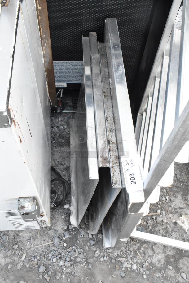 Four metal panels in used condition, showing surface wear. Auction tag "203" attached.