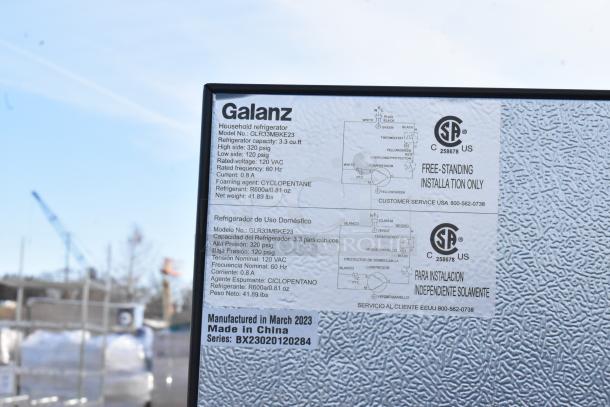 Galanz GLR33MBKE23 mini cooler label displays model details, 3.3 cu. ft. capacity, 120 VAC, made in March 2023, China.