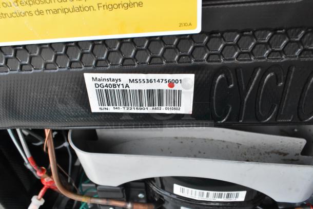 Five mini coolers including Haier HC32TW10SB, Black & Decker BCE46B, Galanz GLR33MBKE23, Mainstays DG40BY1A, 120V, 1 phase. Tags show Mainstays model DG40BY1A and serial information.