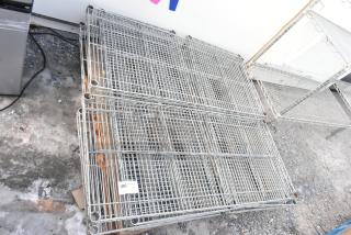 Lot of 8 chrome finish wire shelves, stacked on a pallet. Includes visible tag reading "206 Qty 8." Suitable for storage.