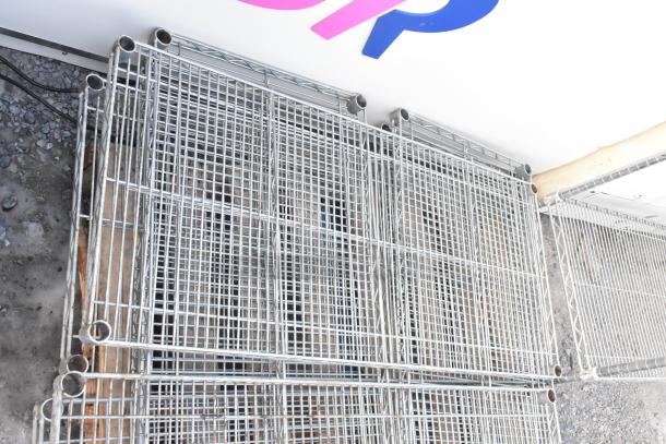 Lot of 8 chrome finish wire shelves in good condition, featuring sturdy grid design and polished surfaces, ideal for storage.