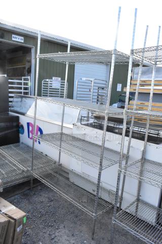 Chrome finish 4-tier wire shelving unit in good condition, featuring sturdy metal construction. Buyer must dismantle.