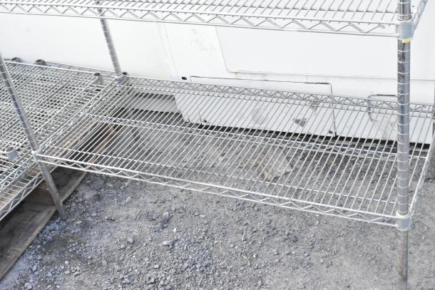 Chrome finish 4 tier wire shelving unit, dismantling required. Ideal for storage, sturdy design, used condition.