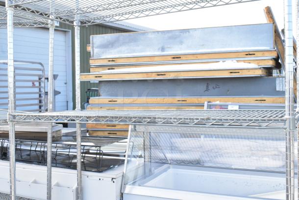 Chrome finish 4-tier wire shelving unit in good condition; buyer must dismantle for shipping.