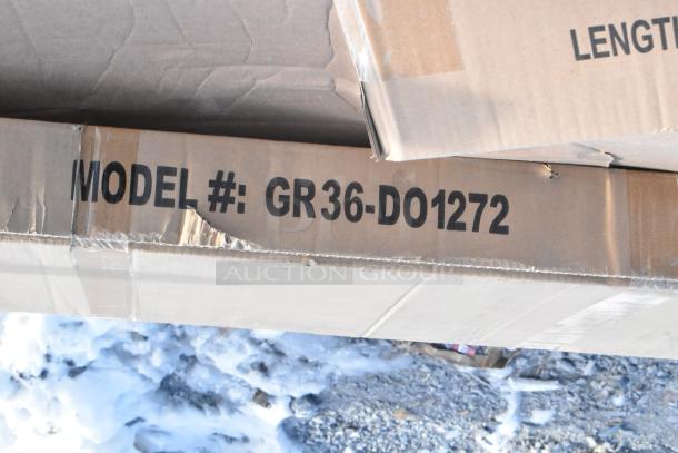 Cardboard box labeled "MODEL #: GR36-DO1272," part of a scratch and dent auction lot, including a cigarette receptacle.