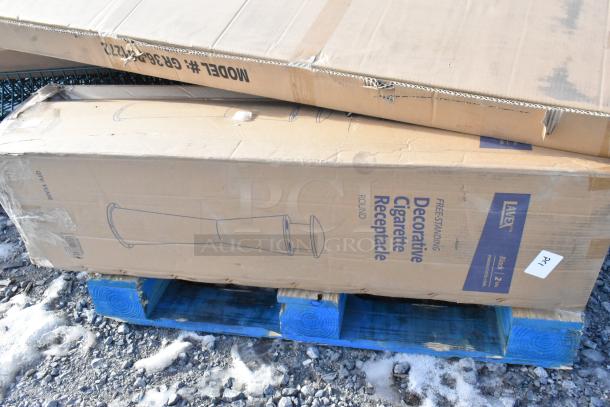Cardboard box labeled "Decorative Cigarette Receptacle," showing signs of wear, on a blue pallet outdoors.