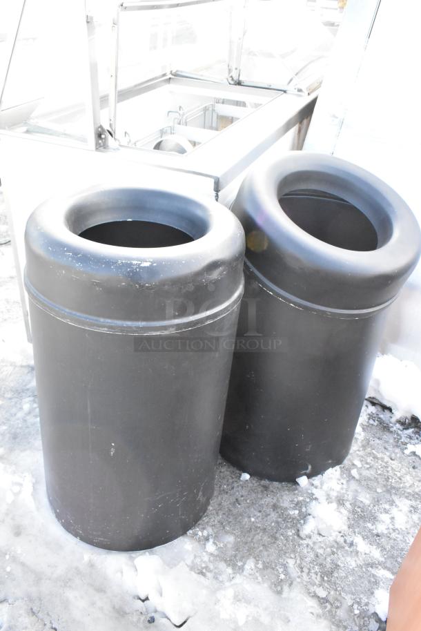 Three trash items: one wooden trash can shell and two black trash cans. Visible wear, suitable for outdoor use.