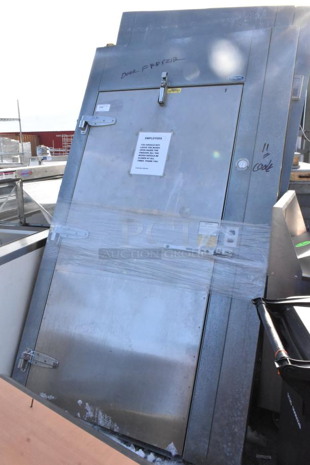 Norlake Walk-In Freezer Box with 2 evaporator fans. Stainless steel finish, visible door latch; label indicates freezer door.