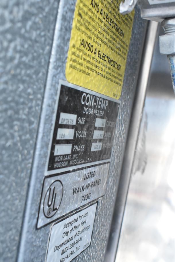 Norlake Walk In Freezer Box tag close-up, showing model details and compliance labels. Features 2 evaporator fans.