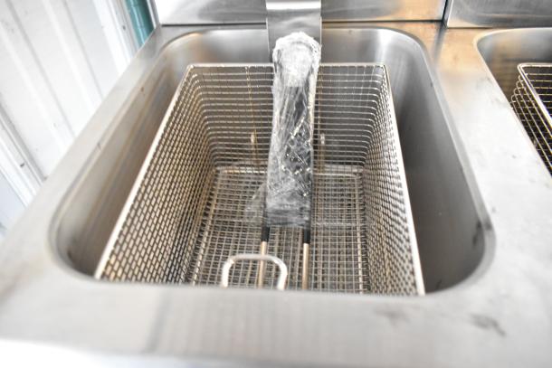 Brand new Avantco 177F202 dual tank electric fryer, 30 lb capacity, with 2 baskets. Some surface scratches visible.