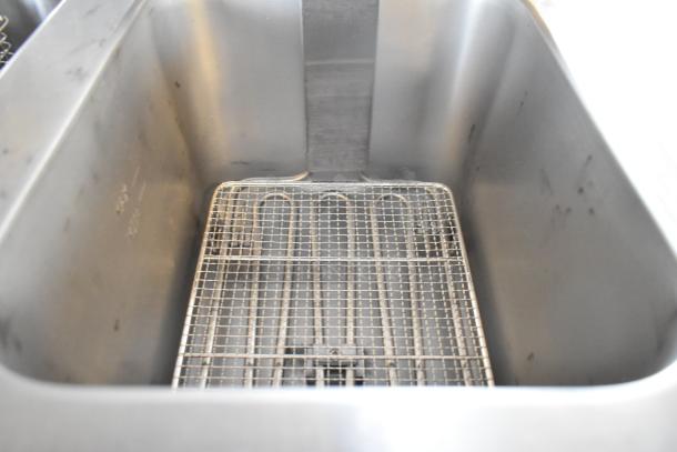 Brand new Avantco 177F202 dual tank electric fryer inner view. Features a 30 lb. capacity with grid basket. Scratch and dent condition.