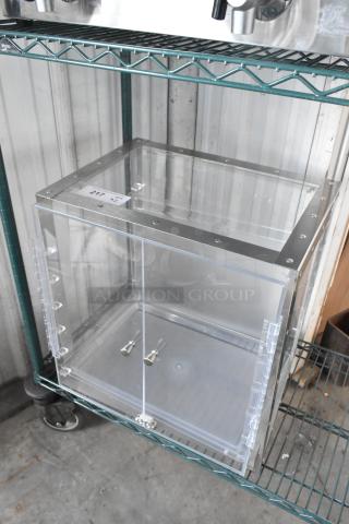 Clear poly countertop cabinet, brand new with minor scratches and dents, featuring metal trim and dual handles.