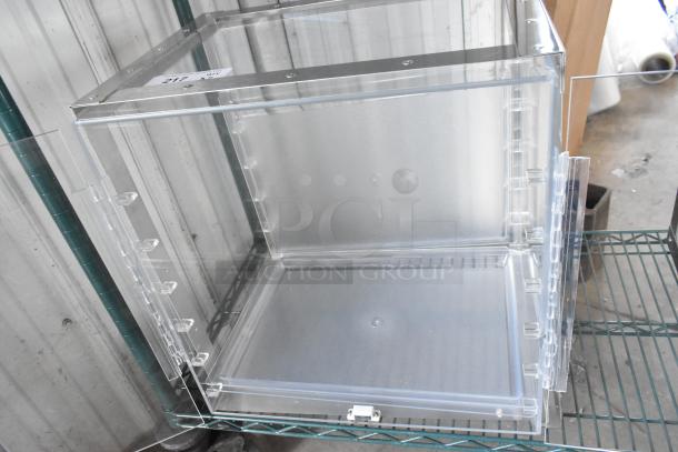 Clear poly countertop cabinet, brand new with minor scratches and dents, metal frame, latch closure, stock label visible.