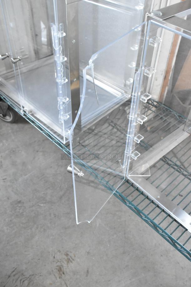 Brand new clear poly countertop cabinet with minor scratches and dents, featuring metal accents and a transparent design.