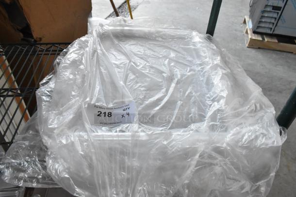 Four new Cal-Mil 325-13-12 clear bakery trays, 13"x18", scratch and dent, in packaging with auction label.