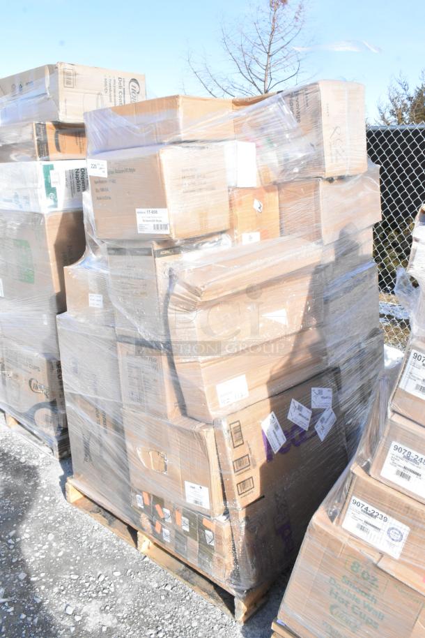 Pallet of mixed boxes labeled "Brand New Scratch and Dent" items including glasses, plates, and sink, wrapped in plastic.