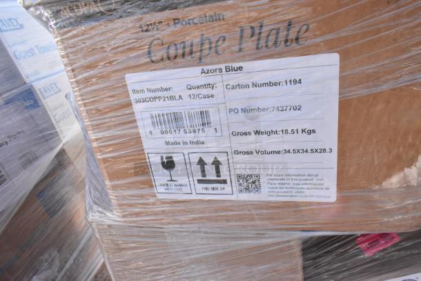 Stack of 32 brand new scratch and dent items including Boltic wall heater, Azora Blue 12.5" porcelain coupe plates, and POS paper rolls labeled "Item Number: 303COPP21BLA, Made in India."