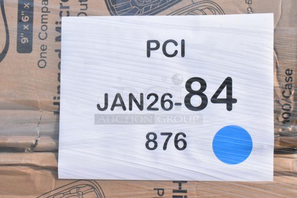 Cardboard packaging of new items labeled "PCI JAN26-84 876" with blue circle, indicating auction details.