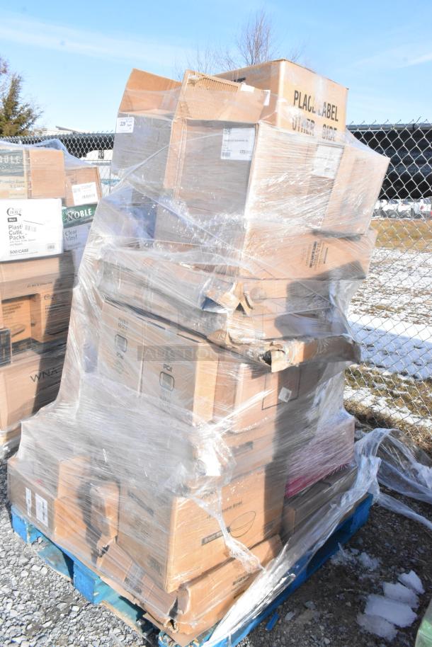 Shrink-wrapped pallet of assorted items including tumblers, lab coats, glasses, and plates; scratch and dent condition.
